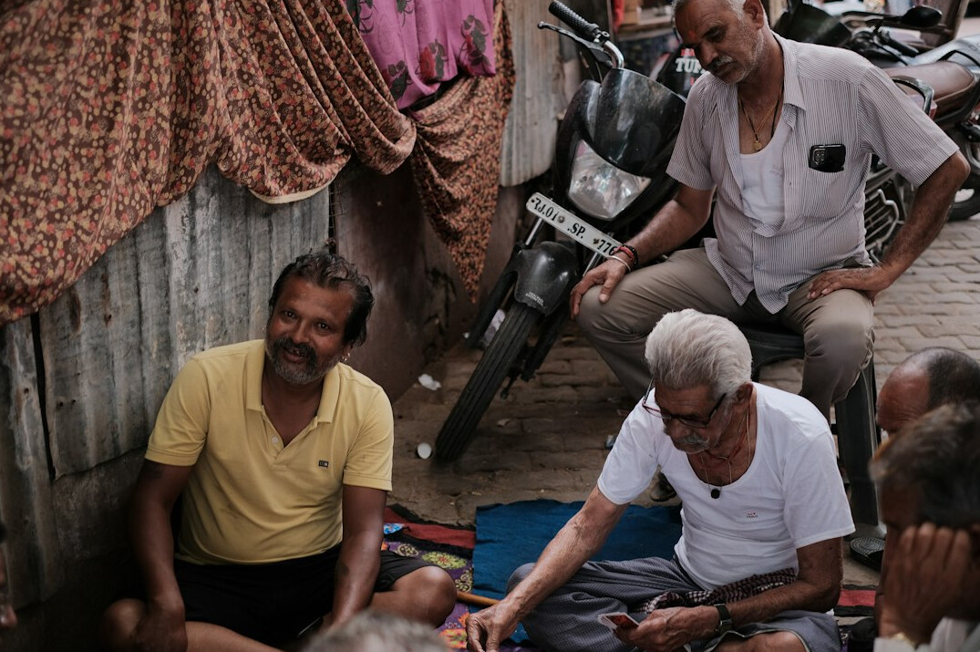 Group of seniors talking in a circle in a bright community room